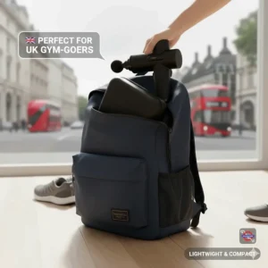 A compact, lightweight percussion massager being packed into a navy backpack in a London setting, ideal for UK gym-goers and commuters.