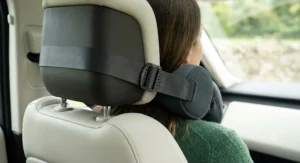 Secure, adjustable elastic strap holding a massage pillow firmly in place on a vehicle headrest.