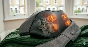 A close-up, detailed view showing the internal gear mechanism and illuminated massage nodes of a shiatsu neck massager resting on a soft throw.