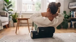 A lightweight, portable body roller resting next to a gym bag, ideal for home workouts or travelling.