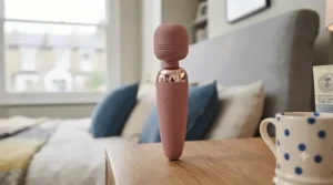 A detailed view of the simple, intuitive power and intensity control buttons on the vibrating wand massager.