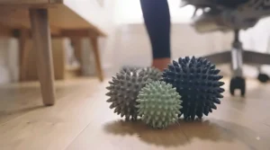Set of two different-sized spiky massage balls for feet and trigger point therapy on various muscle groups.