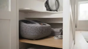 Compact foot massager stored away neatly inside a small living room cupboard.