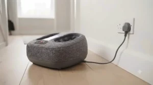 Energy-efficient compact foot massager plugged into a standard UK wall socket.