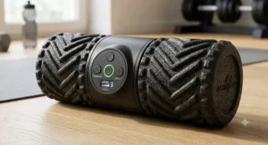 Close-up of a high-density electric vibrating foam roller showing textured ridges and speed setting buttons.
